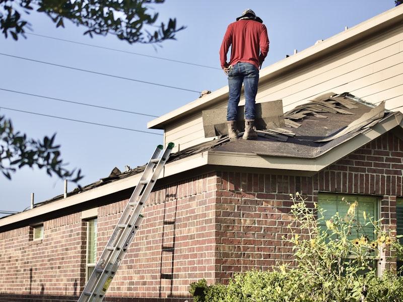 Roofing contractor installing shingles on a residential roof in Edmonton