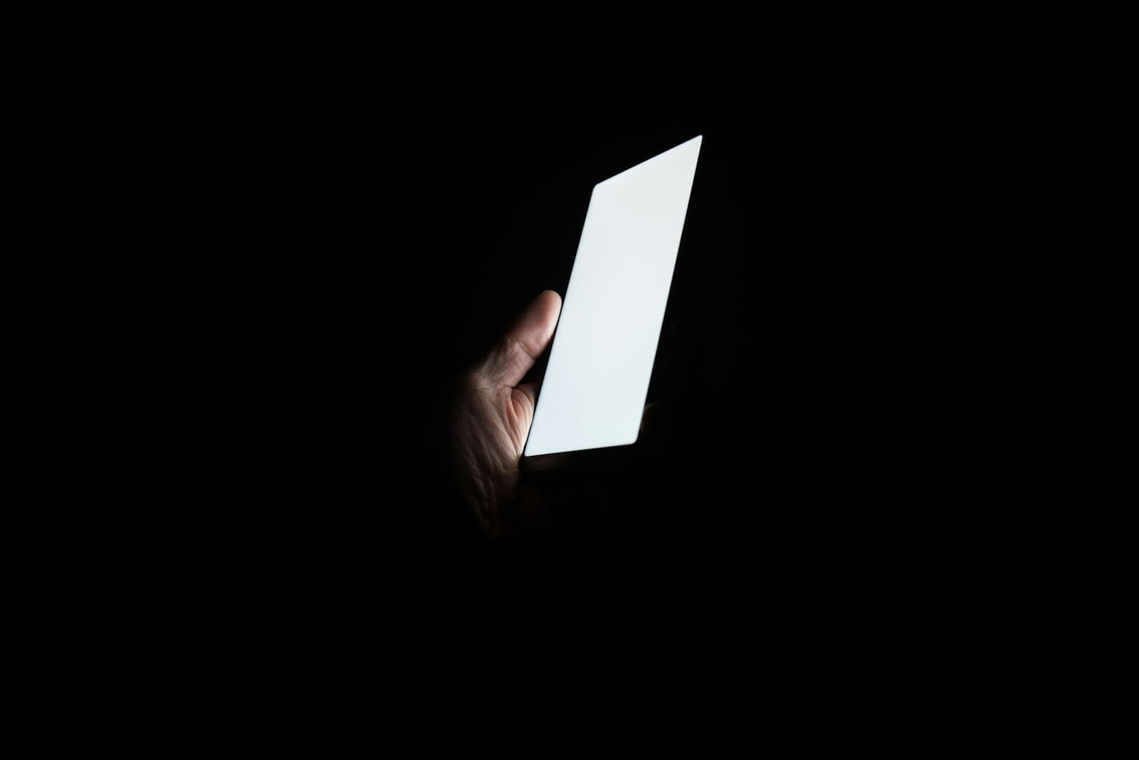 A phone screen lighting a face in the dark