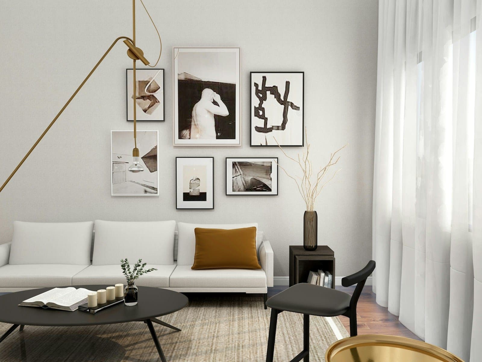 A living room with a white sofa and framed art on the wall
