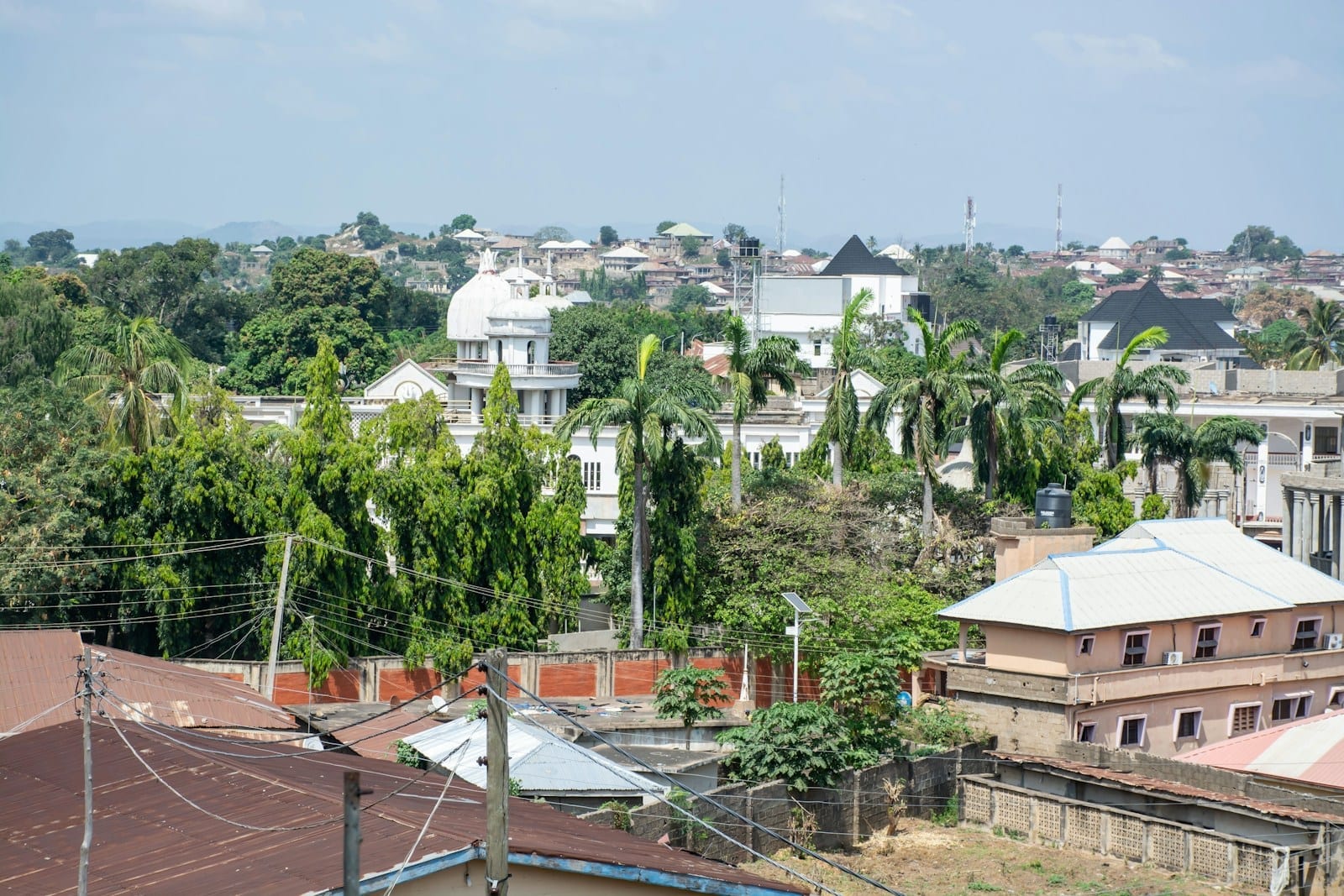 A Lagos neighbourhood of houses and trees viewed from above in daylight