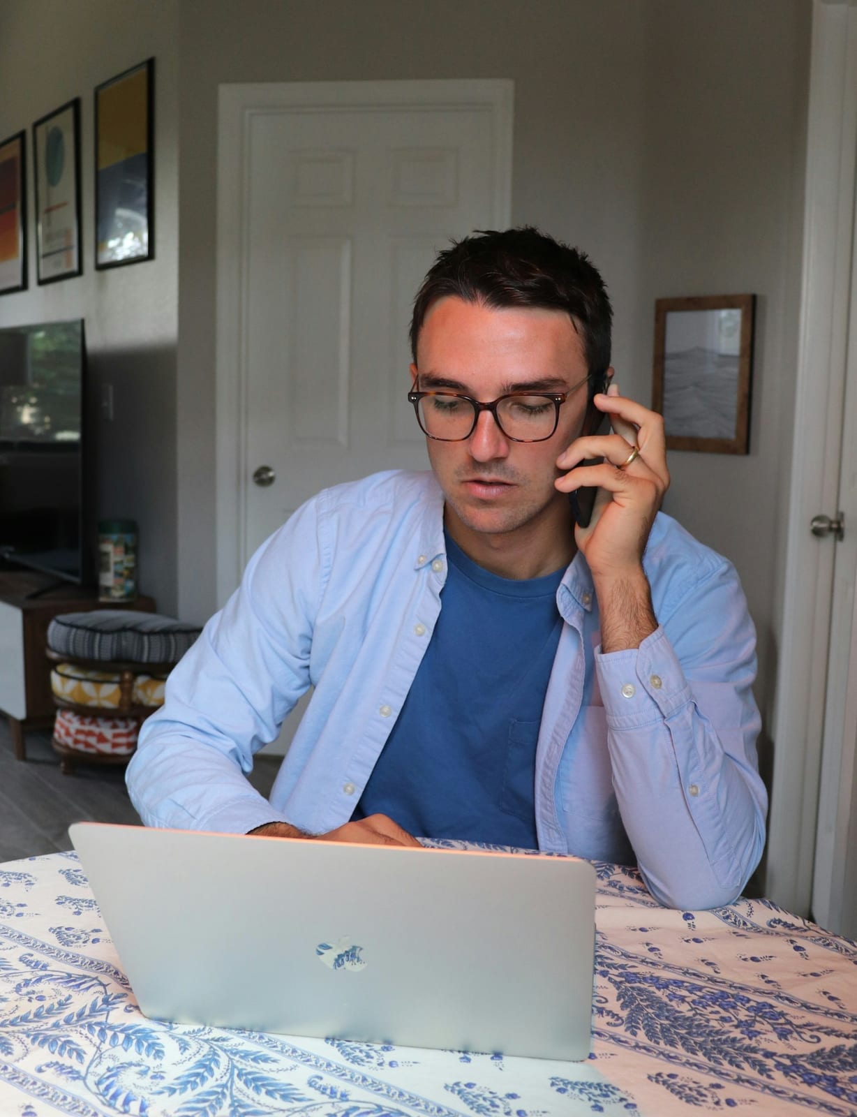 A woman wearing glasses working at a desk
